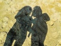 Shadow of two women in the sand