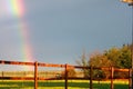 Rainbow with fence in front