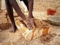 Ghanaian worker forming mud brick