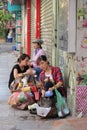 Hanoi, Viet Nam - July 05,2019: A woman salesperson is selling foods in the street