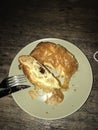 A sad chocolate croissant overexposed in the middle of the night