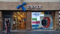 Telenor logo in front of their main shop in Belgrade, with an ATM from the bank Telenor Banka