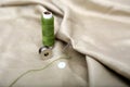 Picture of thread and needle attached in cloth with green Sewing thread and bobbin Royalty Free Stock Photo