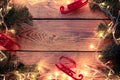 Picture on top of wooden table with burning garland, branches of spruce, Christmas toys. Royalty Free Stock Photo