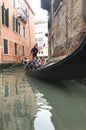 Tourists riding in a gondola in Venice Italy Royalty Free Stock Photo