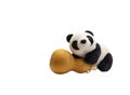 A toy panda leaning on a gourd on a white background