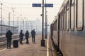 Passengers waiting to board a train on the platform of Belgrade main train station during a sunny afternoon Royalty Free Stock Photo