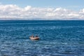 Two fishermen on a boat in Amantani Island, Titicaca Lake, Peru