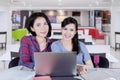 Two happy girls doing schoolwork together Royalty Free Stock Photo