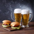 Picture of two hamburgers, glasses with beer Royalty Free Stock Photo