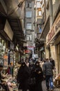 Two muslim women wearing the modest clothing with the traditional scarf is passing in the middle of the spice market