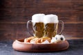 Picture of two mugs of beer and hot dogs on wooden tray Royalty Free Stock Photo