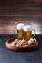 Picture of two mugs of beer and hot dogs on wooden tray Royalty Free Stock Photo