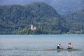 Picture of two young women adults, training on a coxless pair on Bled lake, in Slovenia.