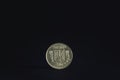 Selective blur on a ukrainian hryvnia coin with Ukraine written in ukrainian and the ukrainian trident coat of arms isolated on a Royalty Free Stock Photo