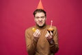 Picture of unhappy stressed young man having unhappy look, feeling tired and worn out with birthday party preparations