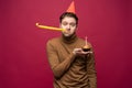 Picture of unhappy stressed young man having unhappy look, feeling tired and worn out with birthday party preparations