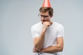 Picture of unhappy stressed young man having unhappy look, feeling tired and worn out with birthday party preparations