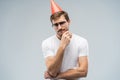 Picture of unhappy stressed young man having unhappy look, feeling tired and worn out with birthday party preparations