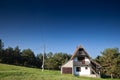 Residential house, a mountain chalet building, called vikendica, in the middle of a grass field meadow in the Balkans in Divcibare