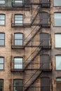 Fire escape stairs and ladder, in metal, on a typical North American old brick building from the Old Montreal, Quebec, Canada Royalty Free Stock Photo