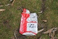 Budweiser beer can crushed on grass at an outdoor event
