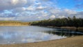 A beautiful little lake next to Frankfurt at a cold but sunny day in winter with beautiful cloudscape. Royalty Free Stock Photo