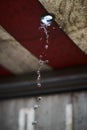 Picture of water drops falling from a red roof with a blurry background Royalty Free Stock Photo