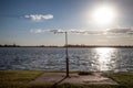 Rusty shower on a beach facing the Blue water of Palic Lake, in Subotica, Serbia, during a summer sunset