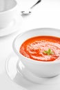 Picture of a white bowl with tomato cream soup. Royalty Free Stock Photo