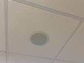 Picture of a white ceiling speaker with white ceiling tiles Royalty Free Stock Photo