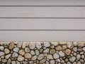 Picture of white concrete wall with stones at the basement and vertical several lines Royalty Free Stock Photo