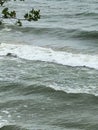 White foamy waves at beach from lake