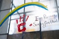 Picture on window with bars of Ucranian flag as a rainbow sign and a red handprint with an inscription of sorry i am Royalty Free Stock Photo