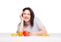 picture of woman with fruits and hamburger in front on white background, healthy versus junk food concept
