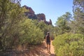 Woman hiking on a desert path through a canyon