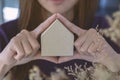 Picture of woman holding paper house model in her hands in house Royalty Free Stock Photo