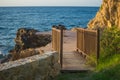 Picture of wooden bridge with blue sea at the background