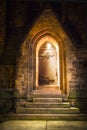 Wooden door in a stone archway at night Royalty Free Stock Photo