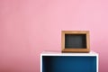 Picture wooden frame and cupboard on pink background