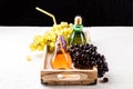 Picture of wooden tray with green and black grapes, two bottles of juice Royalty Free Stock Photo