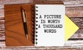 A picture is worth a thousand words Message. Recycled paper note pinned on cork board. Concept Image. Royalty Free Stock Photo