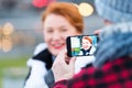 picture of wpman in smart-phone on the street. Portrait of woman in cellular-phone camera.Close up of smart-phone Royalty Free Stock Photo