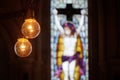 Picture of yellow bulbs in fron of colorfull mozaic windos in the church Royalty Free Stock Photo