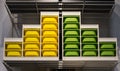 Organized Color Coordinated Storage Bins on a Shelf