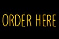 Image of yellow Order here neon sign