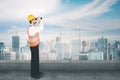 Young architect using a binocular on the rooftop