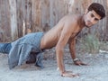 Picture of a young athletic man doing push ups outdoors. Royalty Free Stock Photo