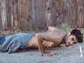 Picture of a young athletic man doing push ups outdoors. Royalty Free Stock Photo