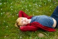 Picture of young beautiful blond man laying on green grass among Royalty Free Stock Photo